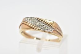 A 9CT GOLD RING, designed as a diagonal line of three single cut diamonds in pave settings to the