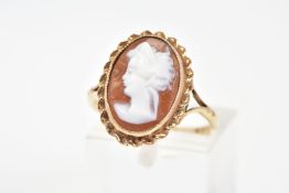 A 9CT GOLD CAMEO RING, of oval design depicting a lady in profile, within a rope twist surround,