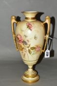 A ROYAL WORCESTER TWIN HANDLED VASE, painted floral detail on blush ivory ground with gilt