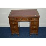 AN EARLY TO MID 20TH CENTURY BURR WALNUT AND BANDED LADIES KNEE HOLE DESK with oxblood gilt tooled