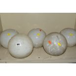 A SET OF FIVE OPAQUE WHITE GLASS SPHERICAL CEILING LIGHT SHADES WITH FOUR OVER PAINTED METAL