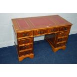 A MODERN YEW WOOD PEDESTAL DESK with ox blood gilt tooled triple inlaid top and nine assorted
