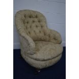 A LATE VICTORIAN FOLIATE GOLD UPHOLSTERED BUTTON BACK BEDROOM ARMCHAIR, on turned legs and