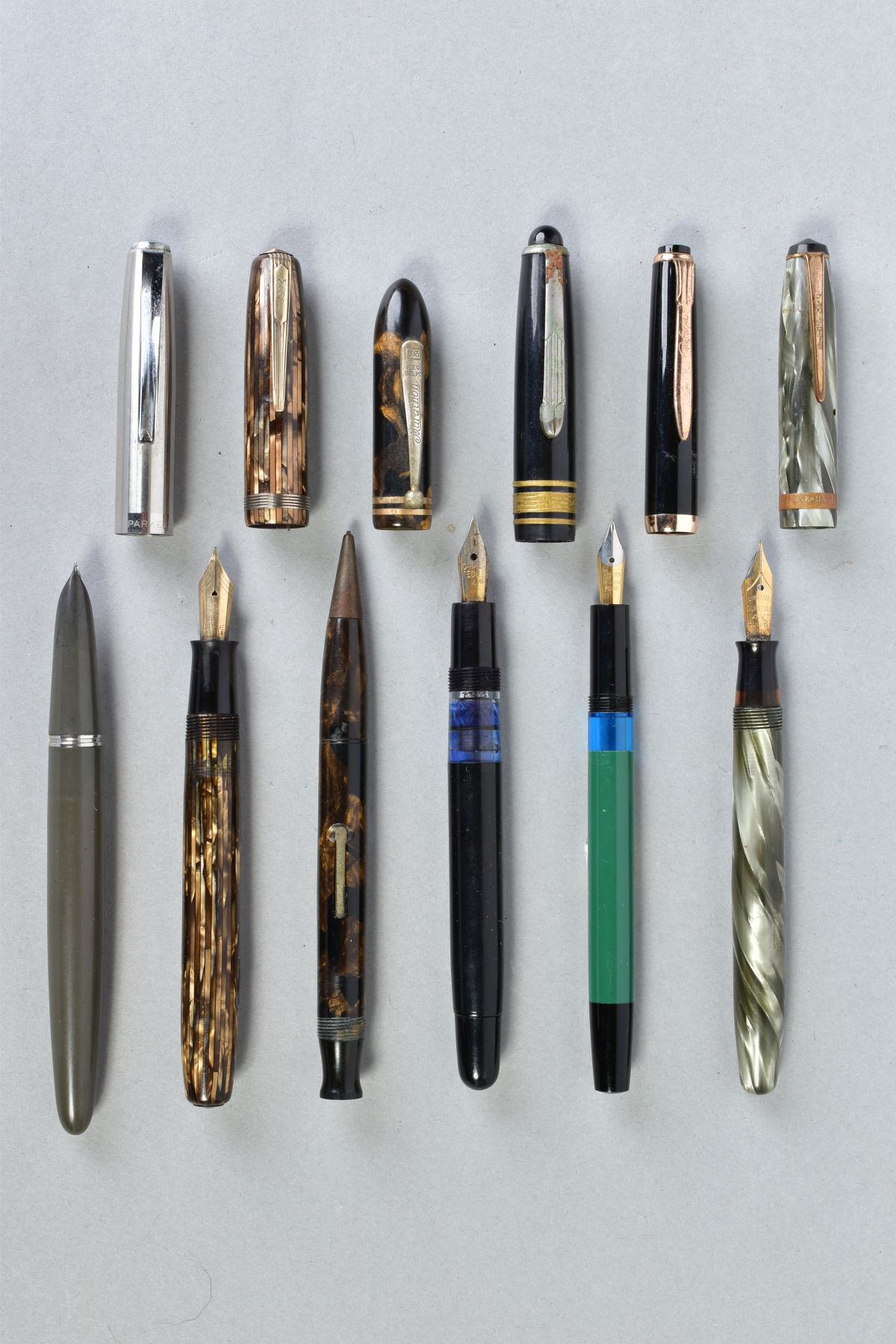 A COLLECTION OF SIX VINTAGE FOUNTAIN PENS including a Moore 94A in striped golden brown with a