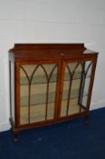AN EARLY TO MID 20TH CENTURY WALNUT TWO DOOR CHINA CABINET with two glass shelves on claw and ball