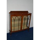 AN EARLY TO MID 20TH CENTURY WALNUT TWO DOOR CHINA CABINET with two glass shelves on claw and ball