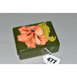 A SMALL MOORCROFT POTTERY RECTANGULAR COVERED POT, 'Hibiscus' pattern on green ground, impressed
