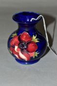 A SMALL MOORCROFT POTTERY VASE, 'Anemone' pattern, on blue ground, impressed backstamp, height