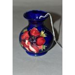 A SMALL MOORCROFT POTTERY VASE, 'Anemone' pattern, on blue ground, impressed backstamp, height