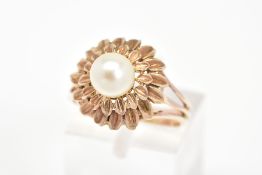 A CULTURED PEARL RING, of a tiered floral design set with a single central cultured pearl, ring size