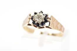 A 9CT GOLD SAPPHIRE AND DIAMOND CLUSTER RING, the central single cut diamond in a star illusion