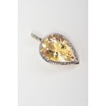 A 9CT GOLD PENDANT, designed with a pear cut citrine within a raised three claw setting and