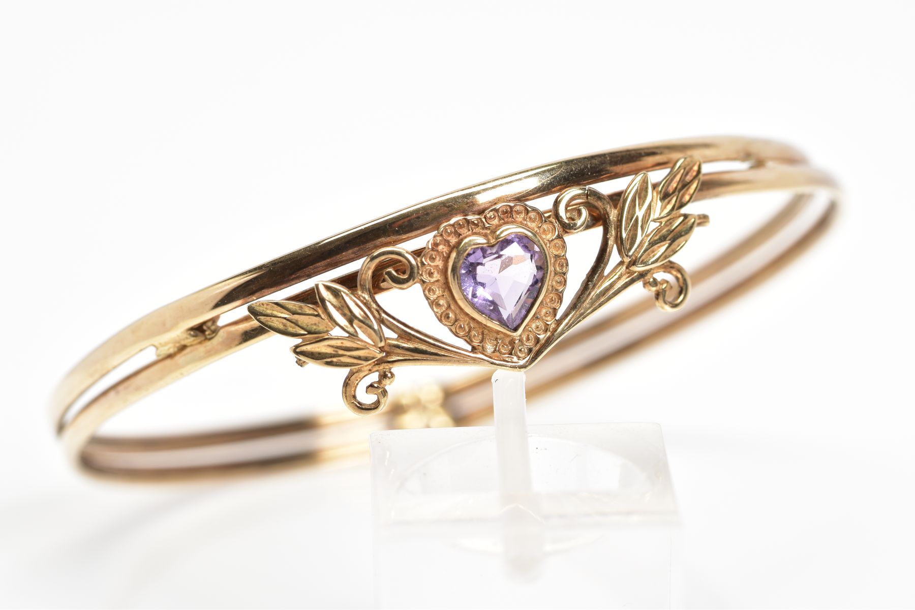 AN AMETHYST BANGLE, designed with a heart shape amethyst in a collet setting within a foliate - Image 4 of 4