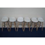 A SET OF SIX MODERN WHITE LEATHERETTE BAR STOOLS on a beech frame