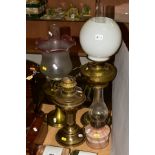 FOUR OIL LAMPS, comprising three brass based oil lamps, two with chimneys and shades and a small