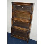 AN OAK FOUR SECTIONAL BOOKCASE, the Globe-Wernicke Co Limited, London, with glazed flap front