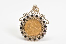 A HALF SOVEREIGN PENDANT, the Victoria 1898 half sovereign within a sapphire and colourless paste