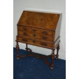 A REPRODUCTION BURR WALNUT AND WALNUT BANDED BUREAU, the top enclosing a fitted interior including a