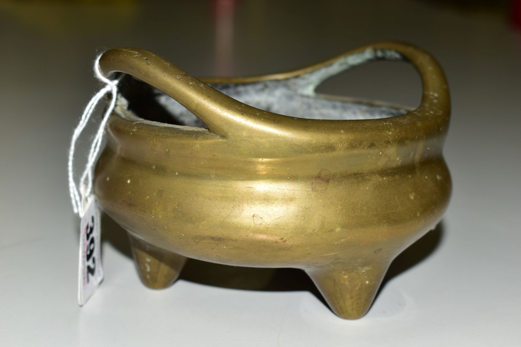 A CHINESE POLISHED BRONZE TRIPOD CENSER, 18th / 19th Century, looped handles, cast mark to - Image 7 of 7