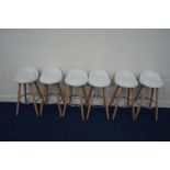 A SET OF SIX MODERN WHITE LEATHERETTE BAR STOOLS on a beech frame