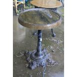 A VICTORIAN CAST IRON PUB TABLE with a footed circular base with foliate detail and a single