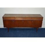 A 1970'S/1980'S TEAK SIDEBOARD three reed front drawers above cupboard doors flanking a fall front