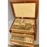 A SECOND HALF 20TH CENTURY WALNUT AND OAK CASED CONTINENTAL WHITE METAL CANTEEN OF CUTLERY FOR