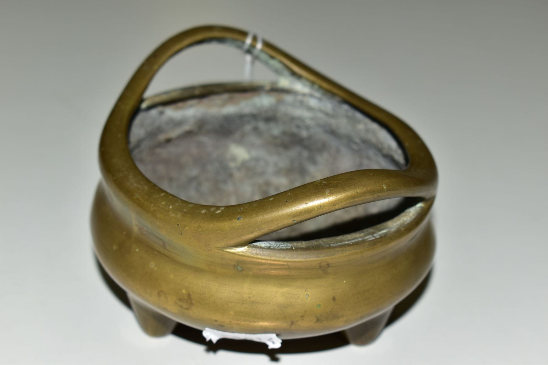 A CHINESE POLISHED BRONZE TRIPOD CENSER, 18th / 19th Century, looped handles, cast mark to - Image 2 of 7