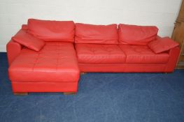 A BRIGHT RED LEATHER LA METEORA CORNER SOFA on wooden block legs together with two cushions,