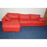 A BRIGHT RED LEATHER LA METEORA CORNER SOFA on wooden block legs together with two cushions,