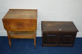 AN OAK PANELLED BLANKET CHEST together with an oak drop leaf tea trolley (2)