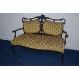 A VICTORIAN MAHOGANY FOLIATE UPHOLSTERED TWO SEATER SERPENTINE FRONTED SETTEE, flanked with two back