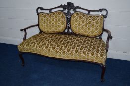 A VICTORIAN MAHOGANY FOLIATE UPHOLSTERED TWO SEATER SERPENTINE FRONTED SETTEE, flanked with two back