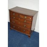 A GEORGIAN MAHOGANY BOWFRONT CHEST OF TWO SHORT AND THREE LONG GRADUATING DRAWERS with circular