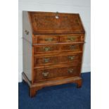 A REPRODUCTION LADIES BURR WALNUT BUREAU with two short and three long graduating drawers, inside