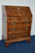 A REPRODUCTION LADIES BURR WALNUT BUREAU with two short and three long graduating drawers, inside