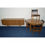 A 1980'S ROSEWOOD FINISH DINING SUITE, comprising of a circular extending dining table with a single