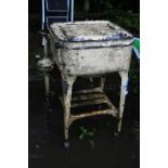 A VINTAGE WASHING MACHINE over painted in cream, standing on four legs with an undershelf (hinge