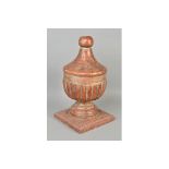 A 19TH CENTURY PAINTED GESSO FINIAL, the carved wooden urn shaped finial on a circular foot