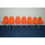 A SET OF SEVEN MODERN ORANGE EIFFEL STYLE CHAIRS