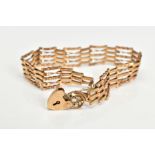 A YELLOW METAL GATE BRACELET, links with twist design, fitted with a gold heart padlock clasp,