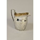 A GEORGE III SILVER HELMET SHAPED CREAM JUG, bright cut decoration, maker's mark partially rubbed,