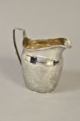 A GEORGE III SILVER HELMET SHAPED CREAM JUG, bright cut decoration, maker's mark partially rubbed,