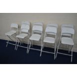 A SET OF NINE MODERN WHITE FOLDING BAR STOOLS