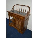 A GERMAN OAK SERVING CABINET, with an arched spindled back, ebonised insert top, three various
