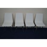 A SET OF FOUR WHITE LEATHERETTE DINING CHAIRS on chrome bases