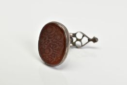AN ANTIQUE MIDDLE EASTERN SEAL, the oval orange panel assessed as paste, carved with floral