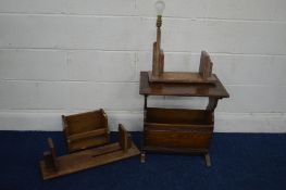 A REPRODUCTION OAK MAGAZINE RACK together with an oak bookstand with a lamp attachment and two other