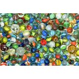 A QUANTITY OF ASSORTED MARBLES, assorted designs, with a homemade embroidered carrying bag