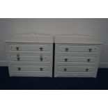 A PAIR OF MODERN CREAM CHEST OF THREE DRAWERS with a shaped gallery back, width 92cm x depth 45cm